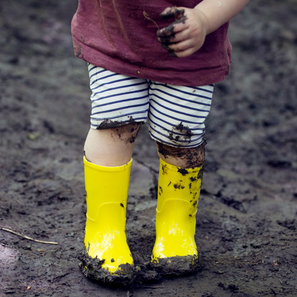girl standing in mud